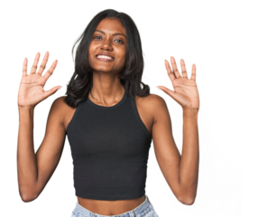 Portrait of a young Indian woman showing number ten with hands.