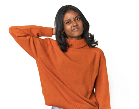 Portrait of a young Indian woman touching back of head, thinking and making a choice.