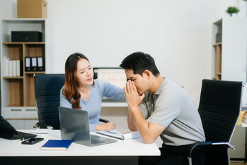 Furious two Asian businesspeople arguing strongly after making a mistake at work
