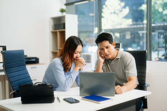 A stressed business team in shock after financial failure. Upset colleagues brainstorm solutions, reacting to bad news - Powered by Adobe