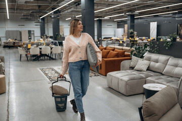 Fototapeta premium Woman Shopping for Furniture and Accessories in a Modern Stylish Store