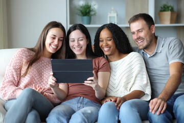 Fototapeta premium Happy interracial group of friends using tablet