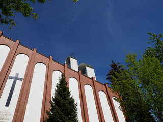 Modern Church Architecture with Cross Symbol Against Bright Blue Sky on Sunny Day