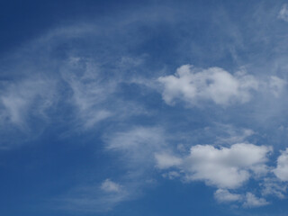 Deep Blue Sky with Dramatic White Cloud Formations Creating Natural Abstract Patterns on Clear Day