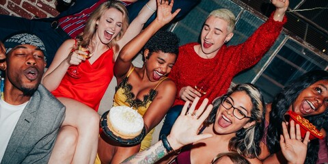Group of diverse friends celebrating at a party. Laughter, joy, and fun as they enjoy the festive...