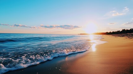 Fototapeta premium Sunlight reflects on gentle waves as the day ends at a serene beach in the evening