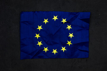 European Union flag on black. Conceptual photo of the dark future European Union. Metaphor for...