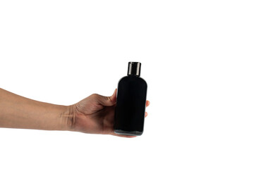 Black plastic bottle in hand on transparent background