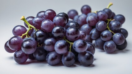 Fototapeta premium White background featuring isolated black grapes
