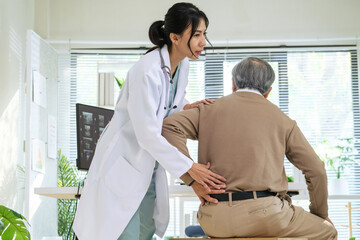 Doctor examining senior patient with back pain during orthopedic checkup at hospital clinic