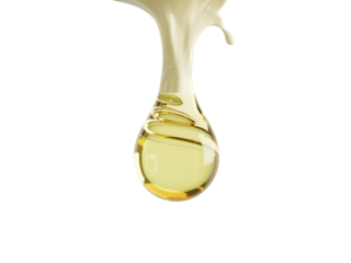 A close up of a single drop of golden liquid dripping down against a black background studio shot