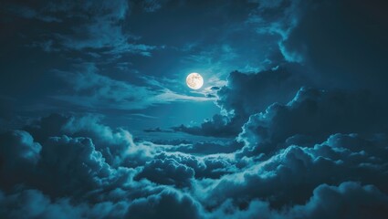 Night sky featuring moon and clouds. Bluish tint.