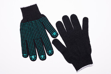 Pair of black work gloves with green rubber grip dots, front and back view on white background