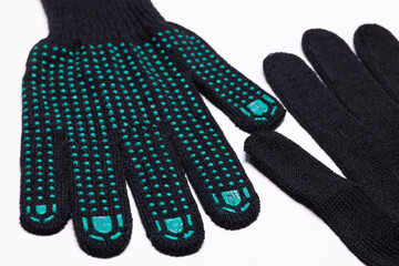 Pair of black work gloves with green rubber grip dots, front and back view on white background