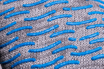 Close-up of textured fabric with blue rubber grip pattern