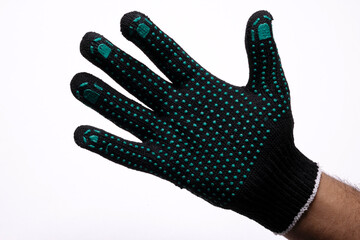 Black safety work glove with green rubber grip dots on white background