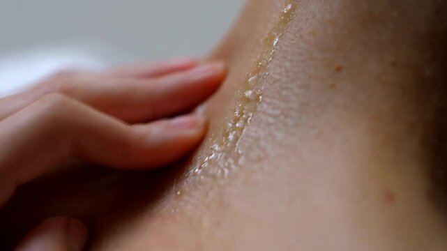 close up of a female neck oil massag 