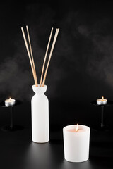 Aromatherapy Candle and Reed Diffuser with Smoke Effect on Black Background – Wellness Product Photo with Elegant Fragrance Concept