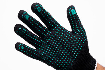 Black safety work glove with green rubber grip dots on white background