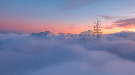 An old sailing ship moves through the fog on a glacier