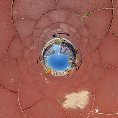 blue hole sphere or globe little planet inside grass or sand or dry ground frame background with...