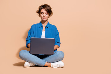 Photo of freelancer specialist lady sitting with netbook coding for distant project on upwork...
