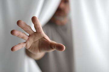 Naklejka premium Closeup of a man offering his hand to someone, with empty space available for text, symbolizing help and support
