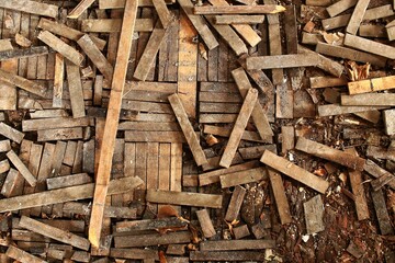 Splintered floor pattern with aged wood fragments and debris in an abandoned interior