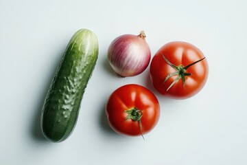 Fresh cucumber tomatoes and red onion on white background vibrant colors healthy food still life