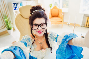 Elegant Aristocratic Woman in Historical Dress and Modern Glasses at Office Providing a Contrast...