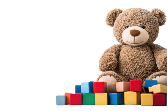Teddy bear sits atop colorful building blocks