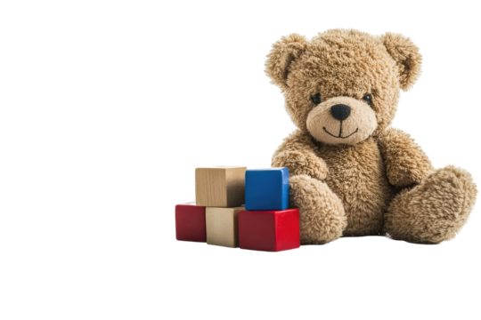 Soft teddy bear sitting beside wooden building blocks