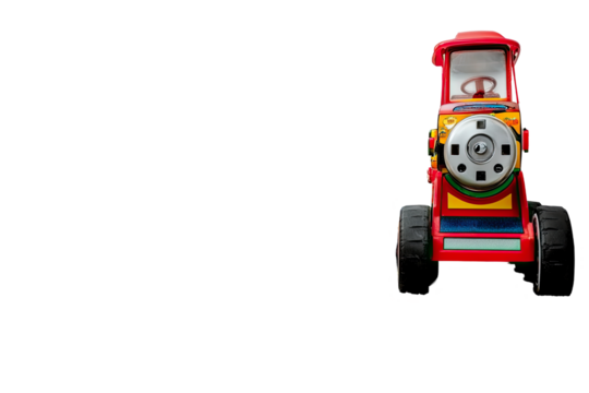 Colorful toy tractor, isolated against black background