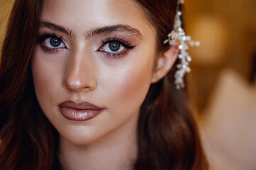 close-up, portrait of a young brunette bride in a white dress with a corset.