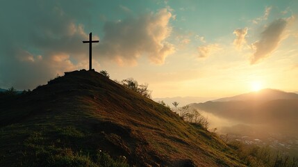 Christian cross standing on a hill during sunrise. Ascension of Jesus concept. Beautiful nature during sunrise or sunset. Cross on top of a hill, Christianity theme.
