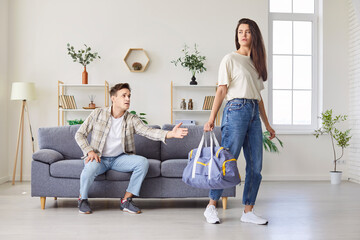 Leaving home, unhappy young couple after fight, woman going away, man depressed and upset, bad...