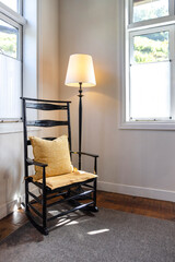 A tranquil cozy corner on the rocking chair by the window