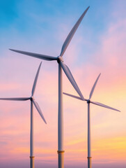 Fototapeta premium Wind turbines against colorful dawn sky create serene scene