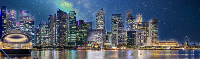 Naklejka premium Singapore CBD City Skyline on the river at Sunset with vibrant colours of the high-rise apartment and office towers with the beautiful colours of the sky. Panorama view of Singapore CBD buildings 