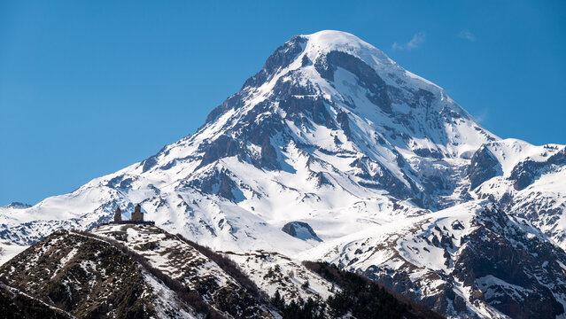 Gergeti Trinity Church and Mount Kazbek near the village of Stepantsminda in the Caucasus mountains in Georgia