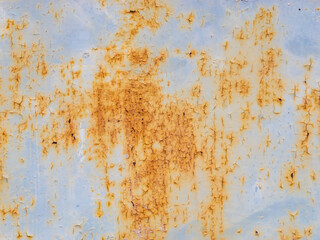 Close-up of orange rust on blue background - industrial corroded metal texture. Detailed macro photo of orange rust on a blue surface. Texture, grunge style, or vintage-themed materials.