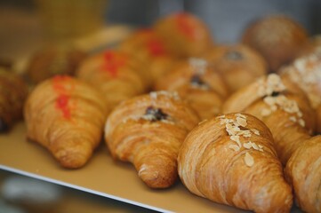 Croissants in a bakery. Cooking pastries in a pastry shop. French crispy croissants close up