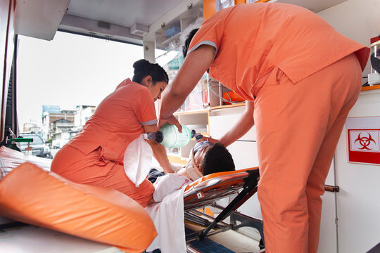 Nurses providing emergency medical assistance to a patient in an ambulance