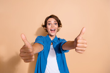Photo portrait of attractive young woman show excited thumb up good quality wear trendy blue...
