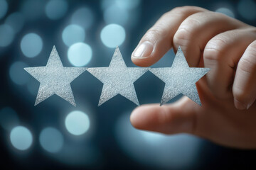 Hand choosing three stars rating on blurred background
