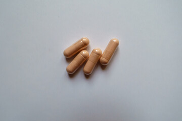 4 pink capsules of palmitoylethanolamide dietary supplement from above
