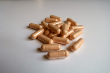 Close shot of heap of pink capsules of palmitoylethanolamide dietary supplement