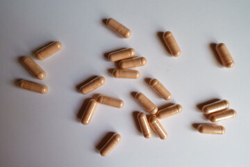Multiple pink capsules of palmitoylethanolamide dietary supplement from above