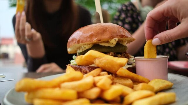 Girl Consuming Fast Food Fries And A Meat Burger In A Cafe
