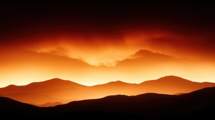 A dramatic sunset over a mountain range, with the sun setting behind the mountains and casting a warm orange glow across the sky.